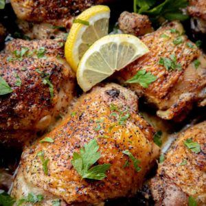Baked Lemon Chicken with lemon slices and parsley over the top.
