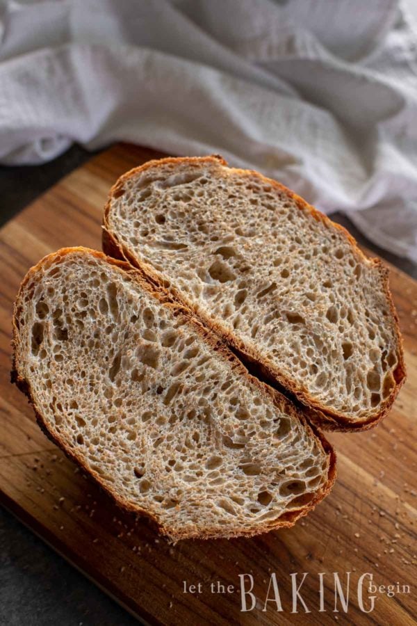 No knead bread recipe cooked and cut in half showing airy center