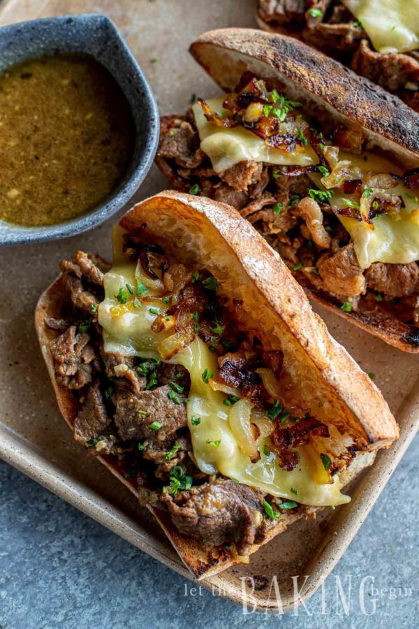 Open faced sandwich made from a French dip recipe with a side of au jus 