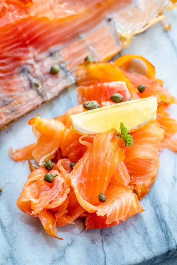 Smoked salmon with capers and a lemon wedge