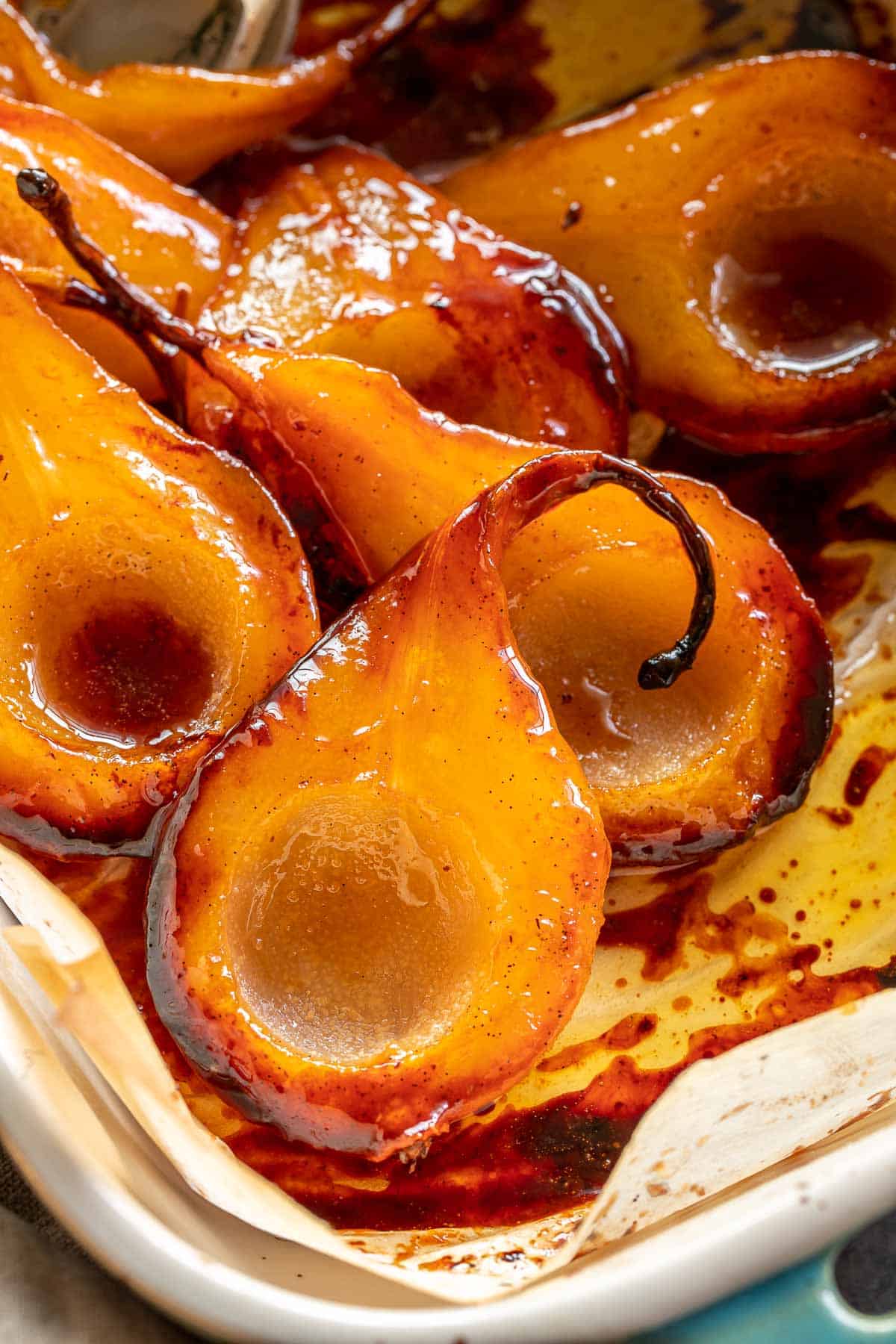Caramelized pears in a baking dish, with edges browned from the caramel. 