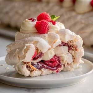 Side view of a piece of the meringue roulade on a plate.