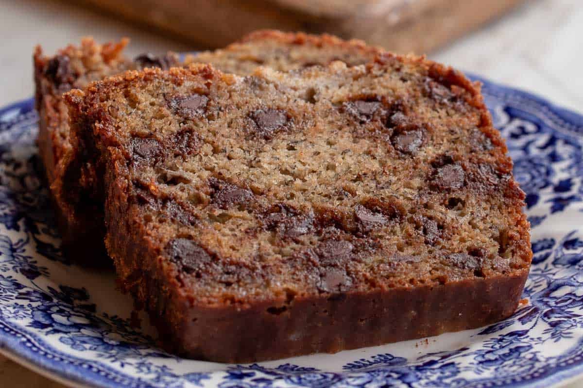 Banana bread slices A slice of chocolate chip banana bread on a blue and white plate