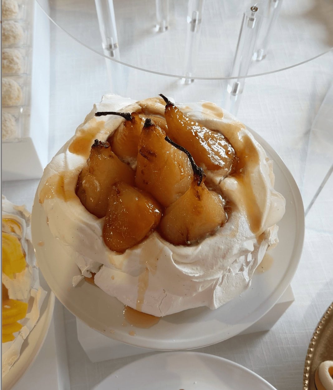 Overhead view of roasted pear pavlova with caramel drizzled over the pears