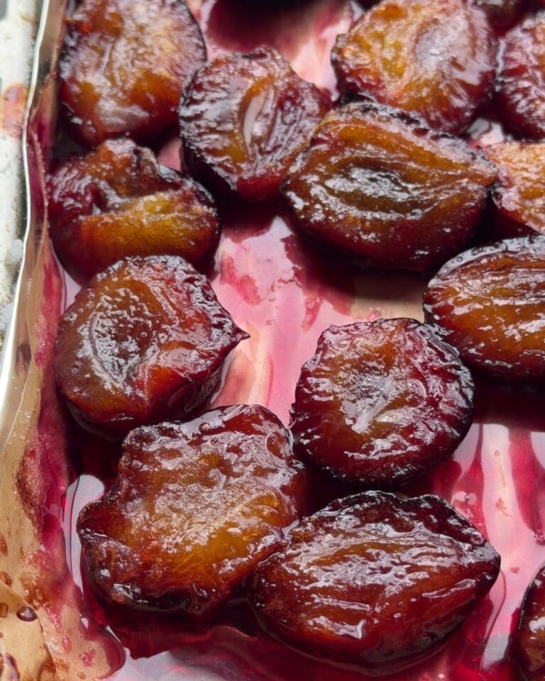 Close-up of caramelized roasted plums for roasted plum pavlova