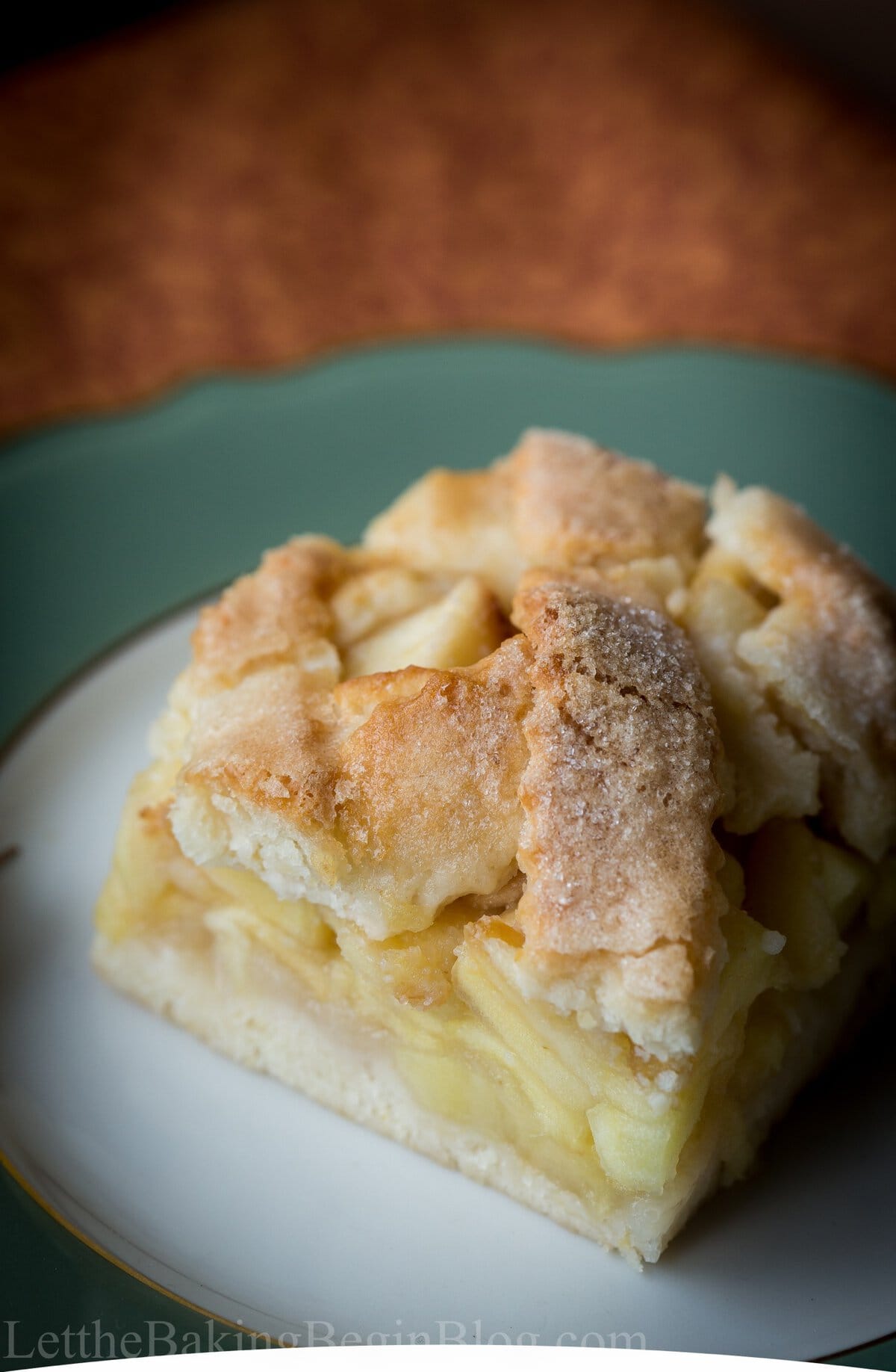 A square of apple slab pie showing the thick apple filling and buttery pirog crust