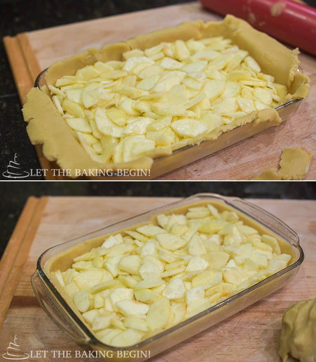 Sliced apples spread over pirog dough in a glass 9x13 baking dish